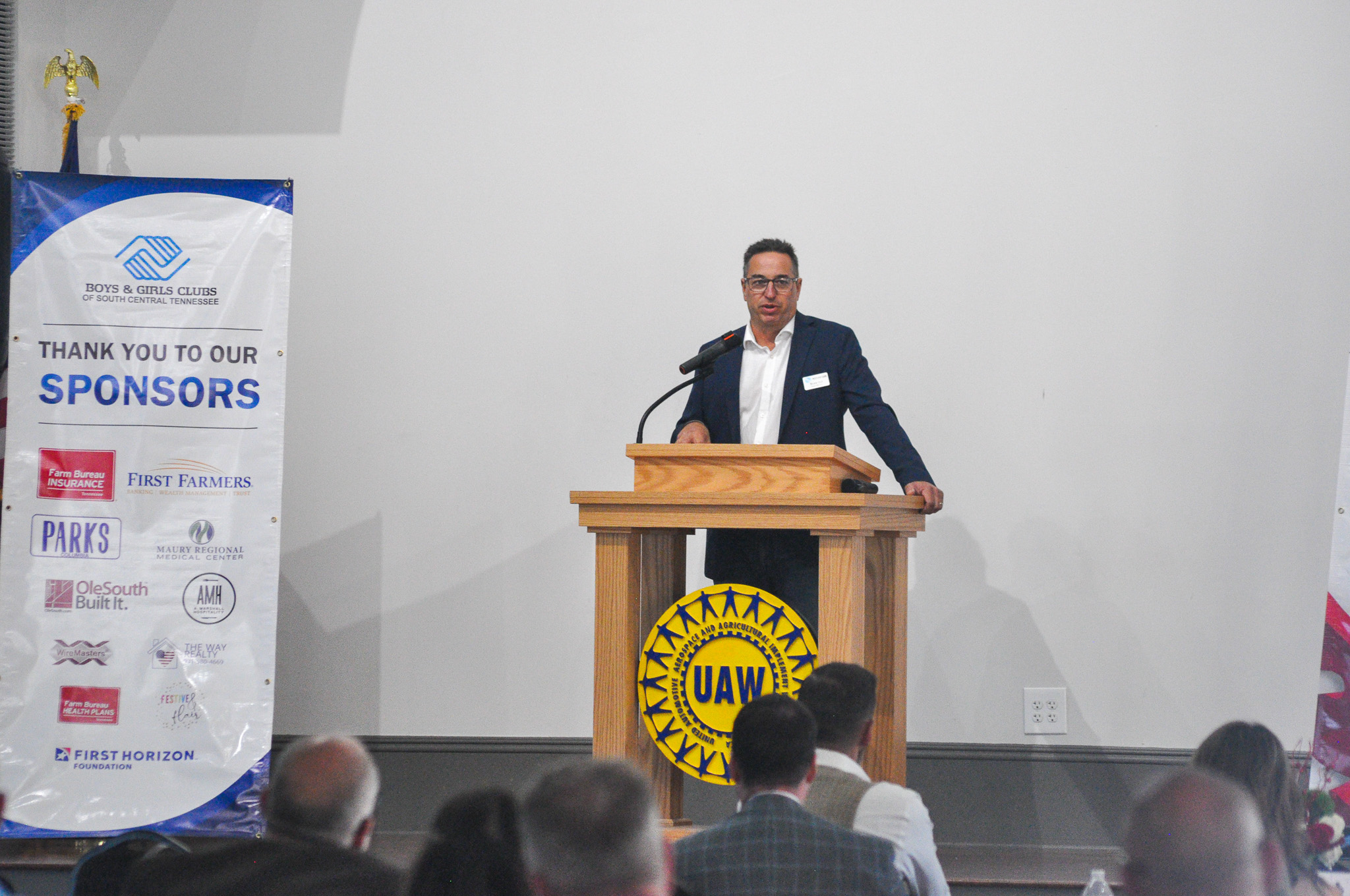 Board Secretary Bruce Hull speaks on stage during the 2026 Spring Hill Hero of the Year Celebration.