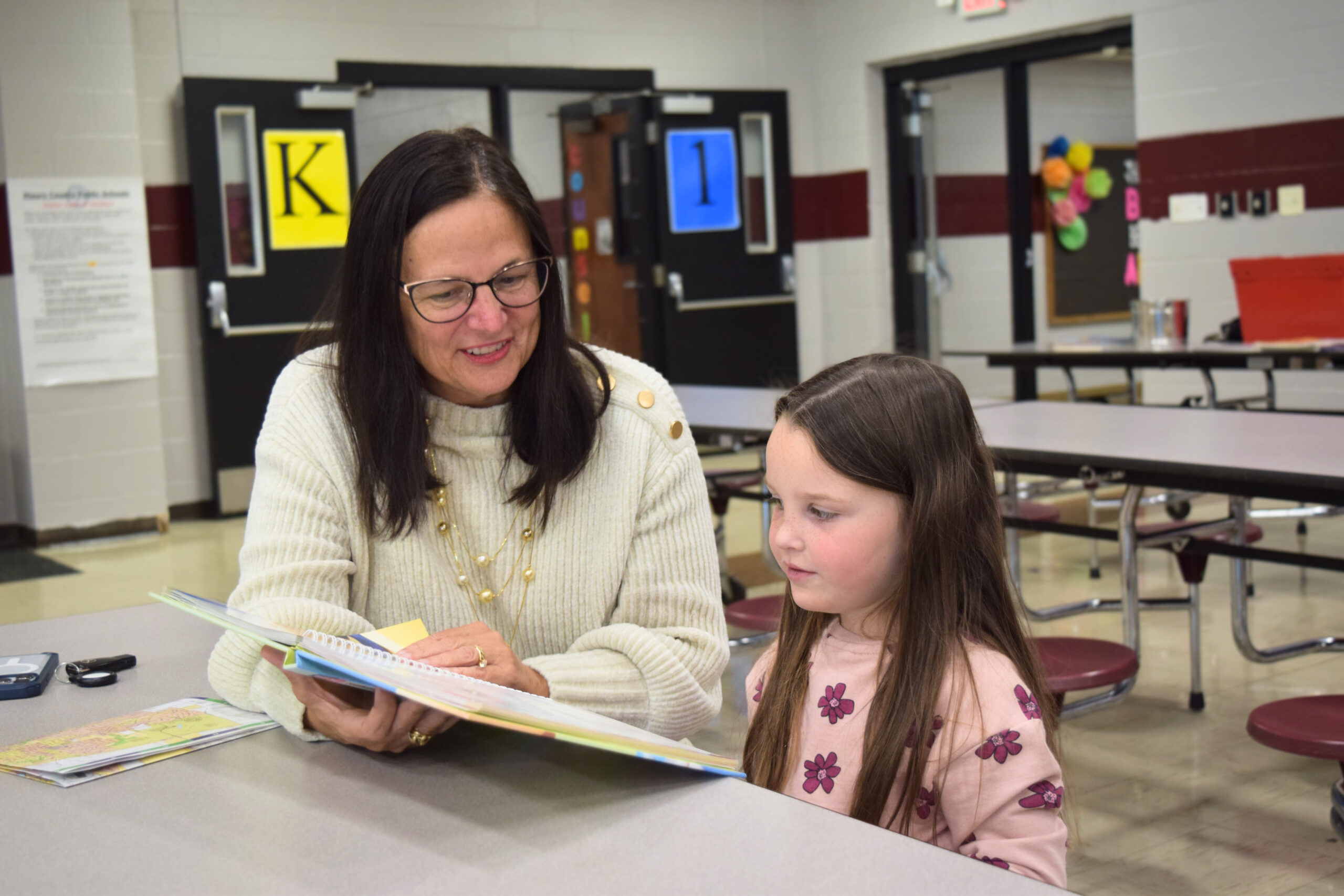 Volunteer Gina Hagaman reading to Emerson at Spring Hill Elementary School