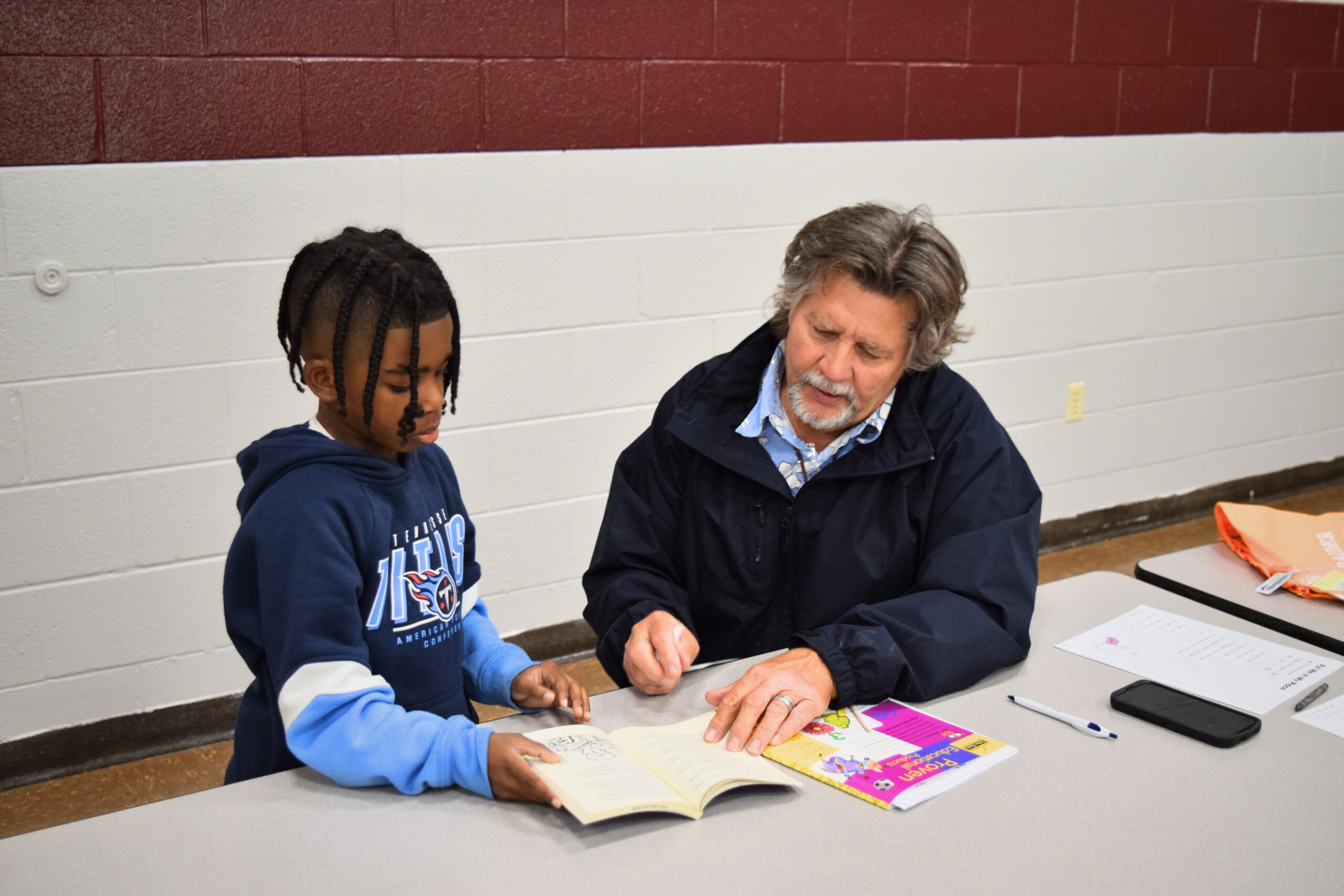 Pictured: Volunteer Robbie Mathis reading to BGCSCTN club member, Lamir Walker at pring Hill Elementary School